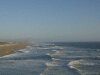 Photo of seashore with gentle waves lapping on sand, low contrast, beach