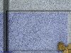 Bue and gray stucco boxes, with stones at bottom right, abstract background, rock
