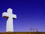 Photo of blocky white cross against a dark blue sky, taken at Bald Knob