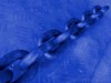 blue photo of chain against a steel plate, low contrast, habits, addicitons, sin