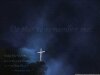 Lord's supper image of white cros on dark hill and dark clouds and says 'do this in remembrance of me' and 'thanks be to God'