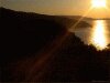 Dark background photo of sunset on seashore, water reflection