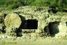 Color photo of a first-century tomb showing a round door made of stone.