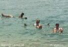 Color photo of swimmers in dead sea, floating in the salt rich, buoyant water.