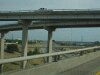 Color photo of raised interstate highway overpasses intersecting. direction, travel