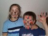 Color photo of kids with painted faces.