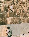 Color close up photograph of people on pyramid in Egypt.